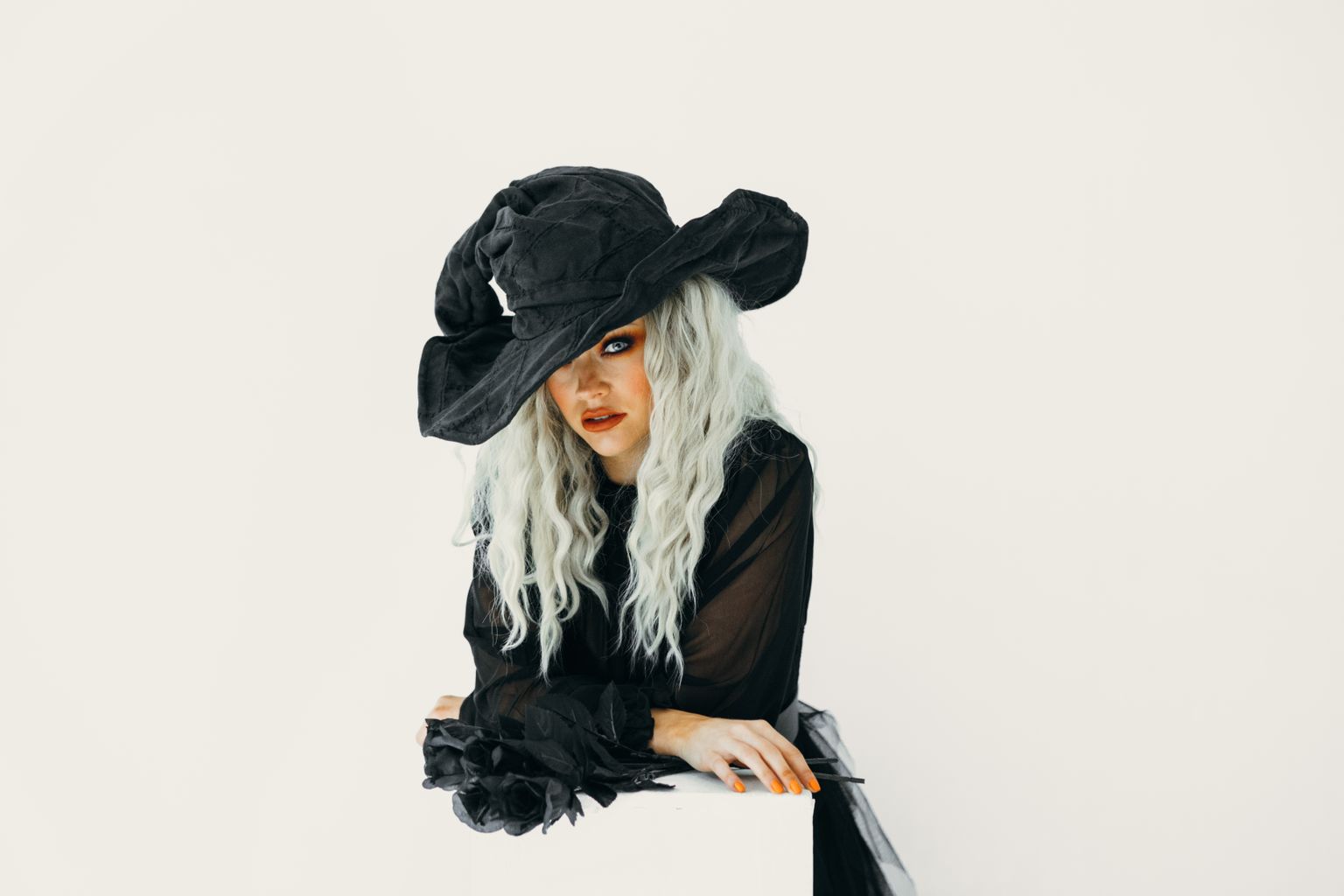 Black outfit Halloween costume with a witch hat