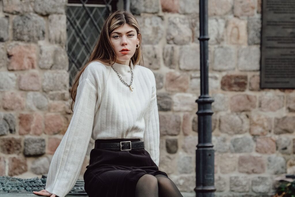 Winter skirt outfit with a white wool sweater, black skirt and opaque tights